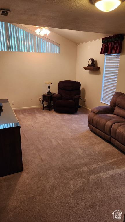 Living area featuring baseboards, carpet floors, a ceiling fan, and visible vents