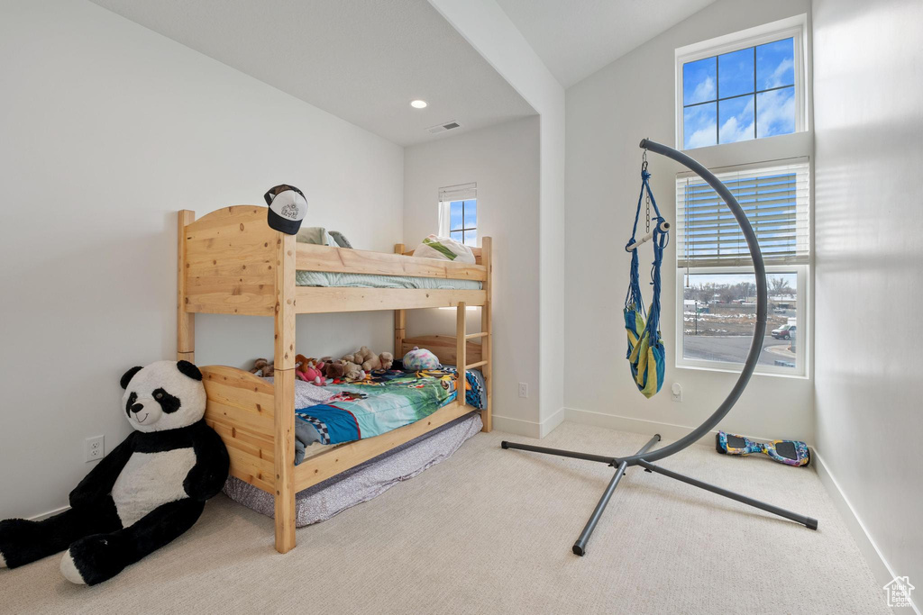 Carpeted bedroom featuring visible vents, recessed lighting, and baseboards