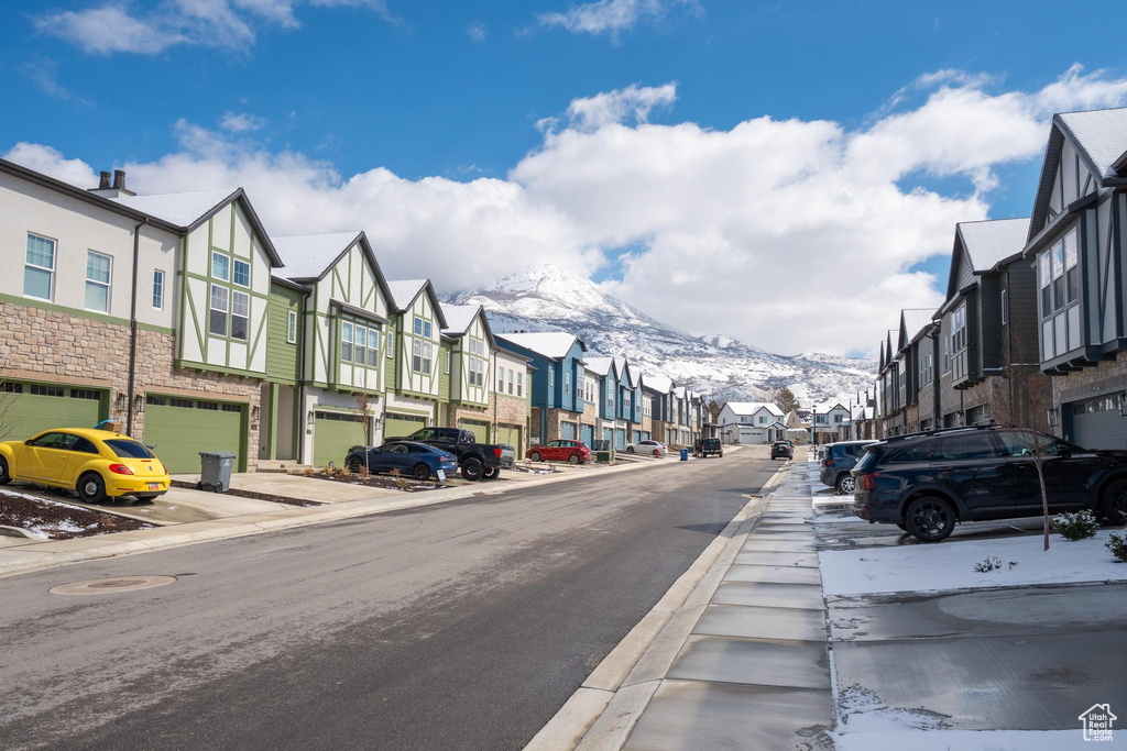 View of street with a residential view, curbs, a mountain view, and sidewalks