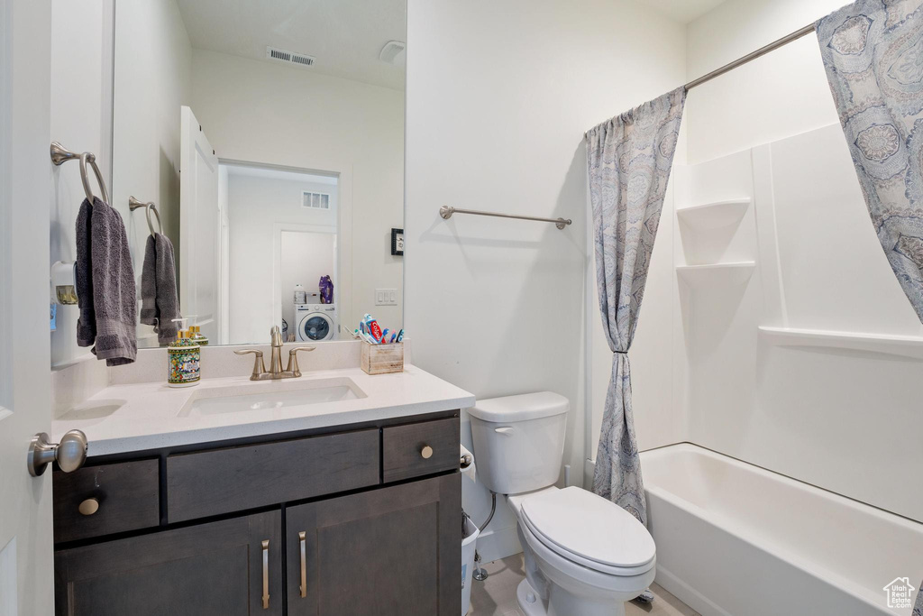 Bathroom with visible vents, toilet, vanity, and shower / bath combo