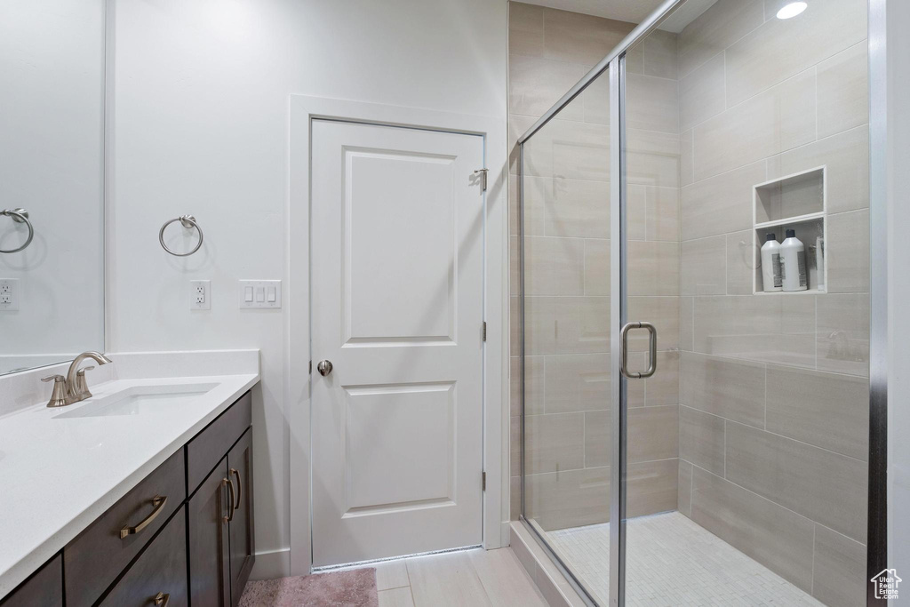 Bathroom with a stall shower and vanity