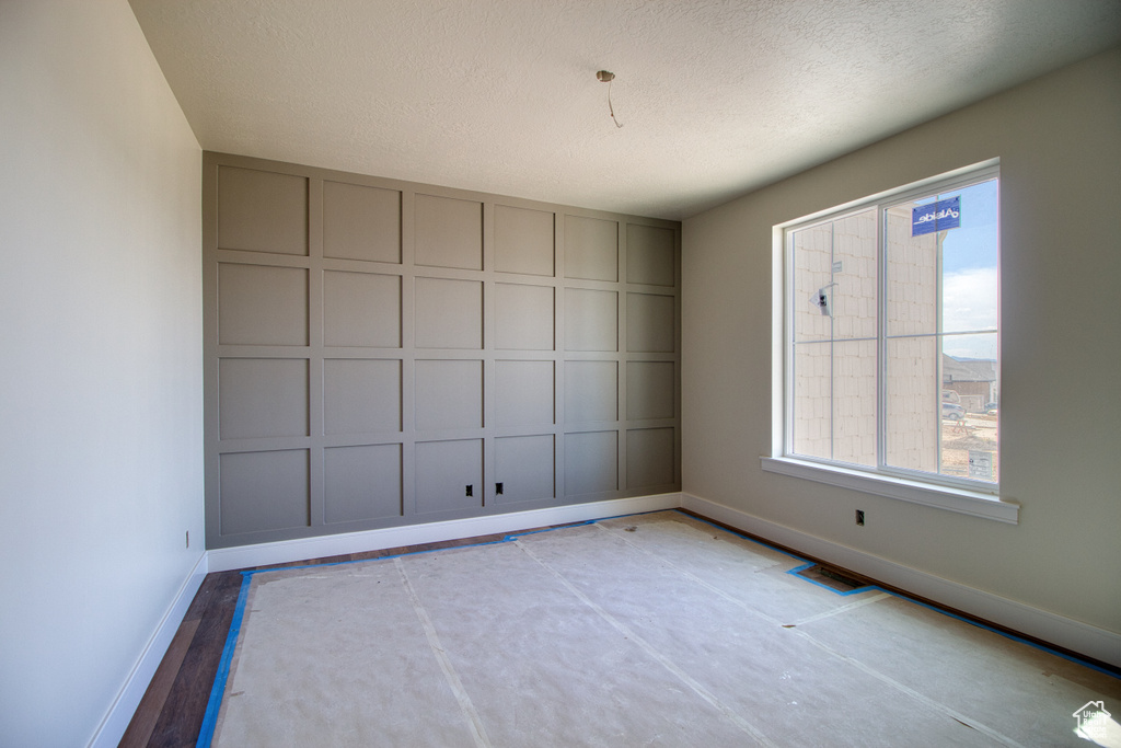 Spare room featuring a textured ceiling and plenty of natural light