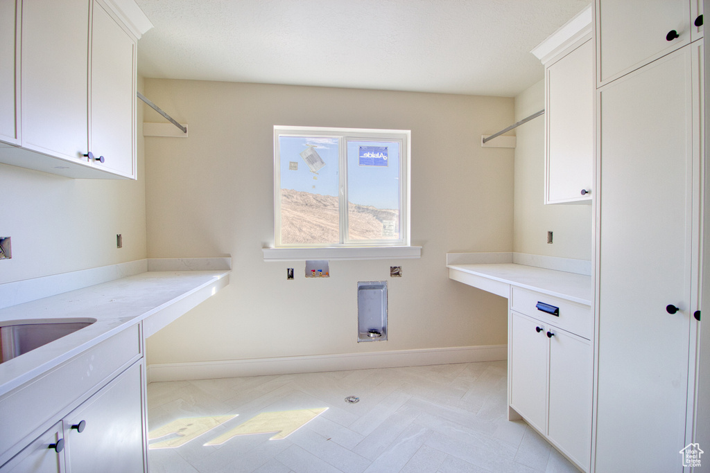 Laundry room featuring cabinet space and washer hookup