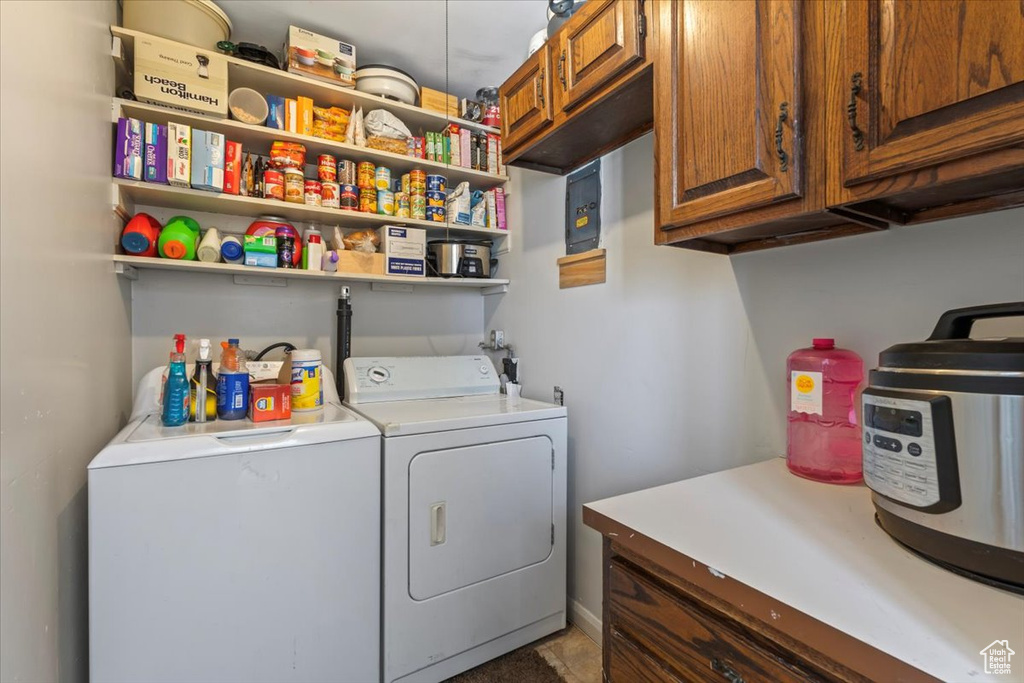 Laundry area featuring washer and dryer and cabinet space