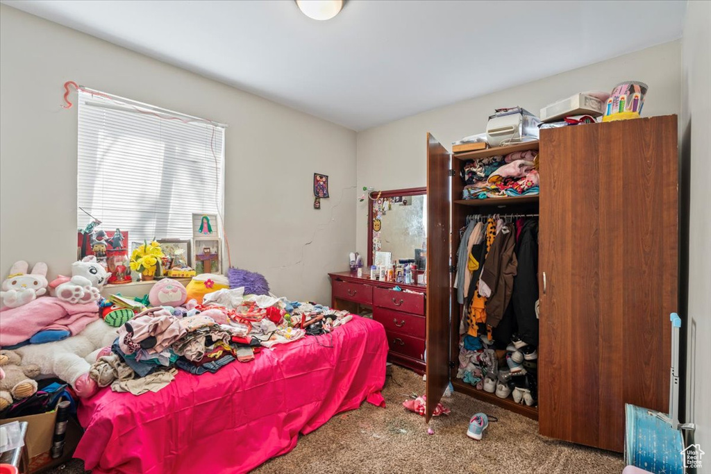 Bedroom featuring carpet flooring and a closet