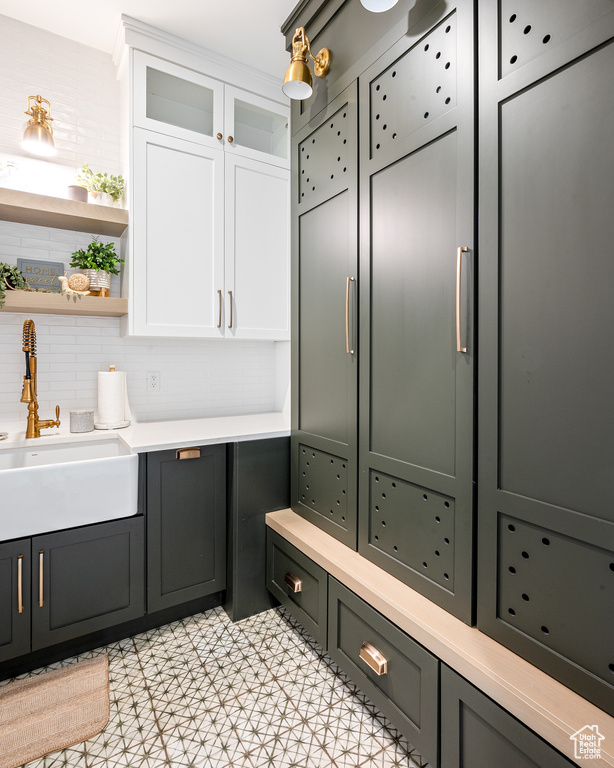 Bathroom with a sink and tasteful backsplash