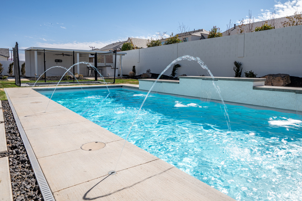 View of pool with fence and a fenced in pool