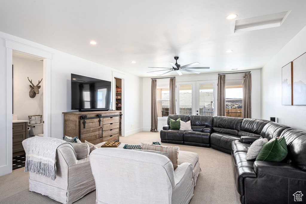 Living area with light carpet, recessed lighting, baseboards, and a ceiling fan