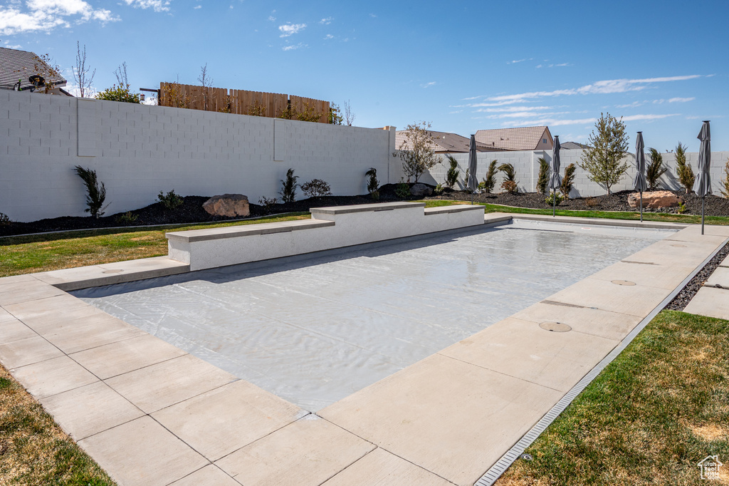Exterior space with a patio and a fenced backyard