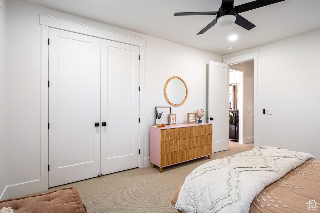 Bedroom with a closet, recessed lighting, light colored carpet, and ceiling fan