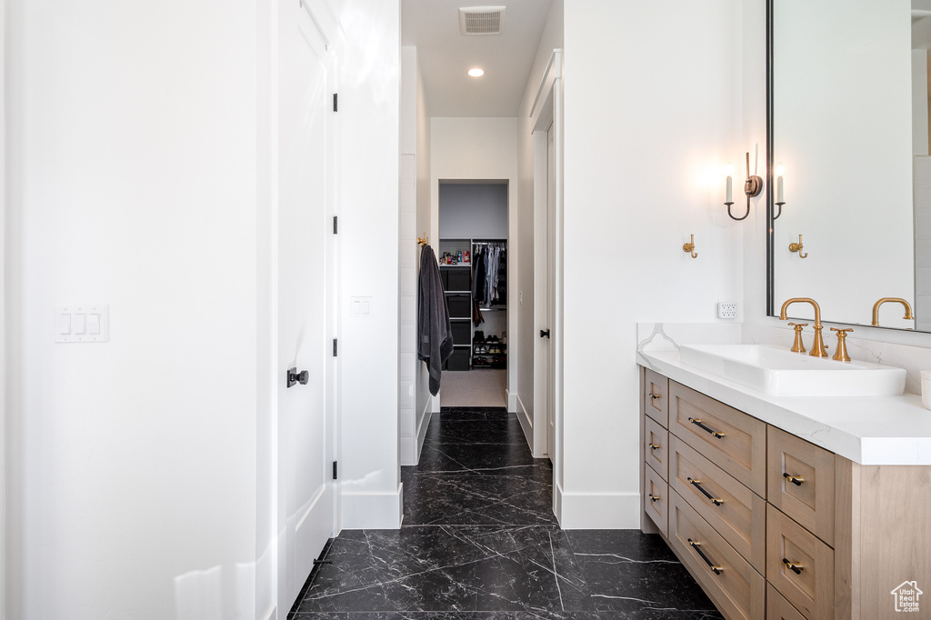 Full bathroom featuring a spacious closet, visible vents, recessed lighting, marble finish floor, and vanity
