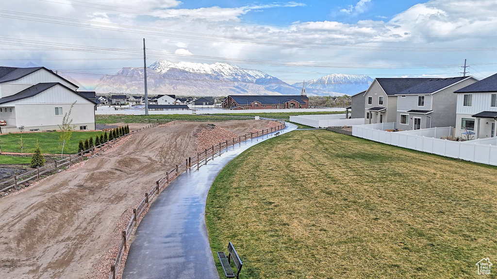 View of yard featuring fence, a mountain view, and a residential view