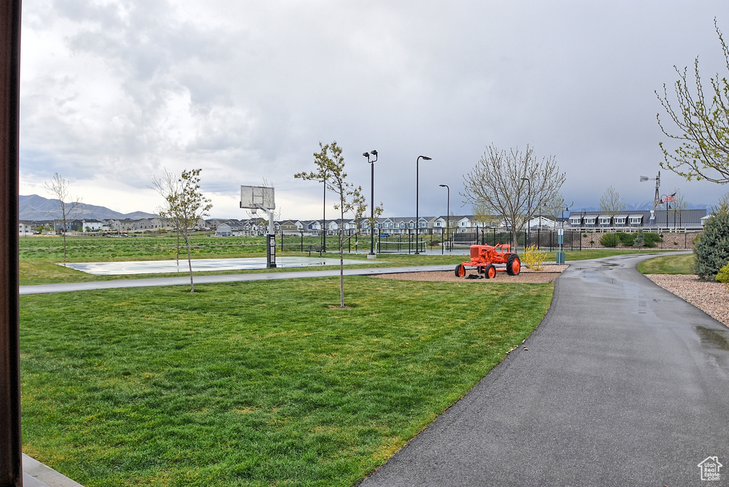 View of home's community with fence and a lawn