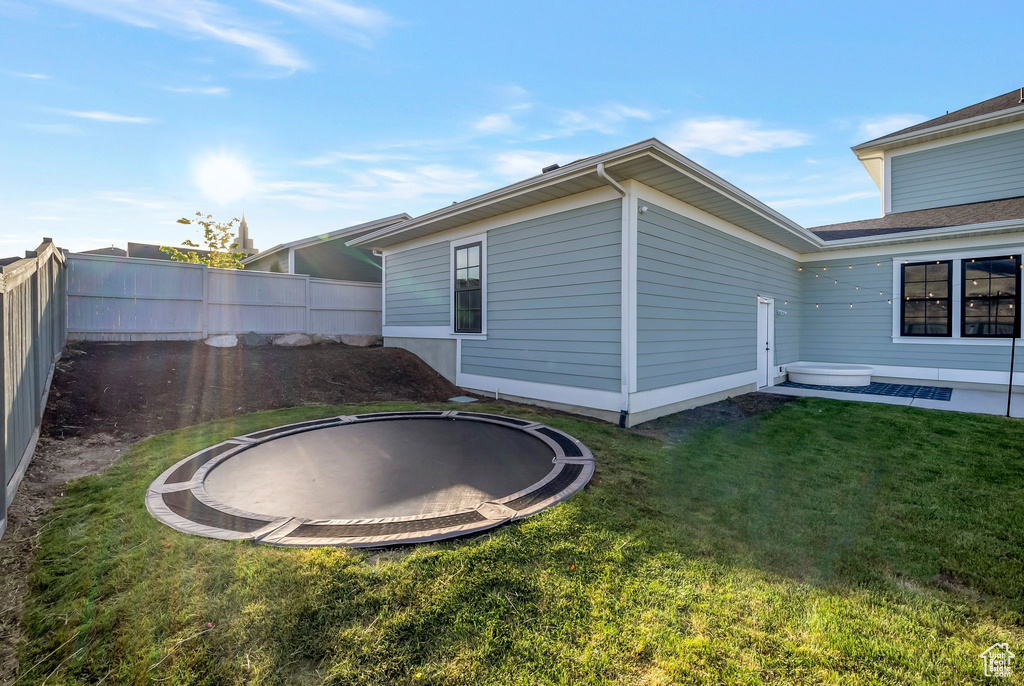 View of side of property with a trampoline