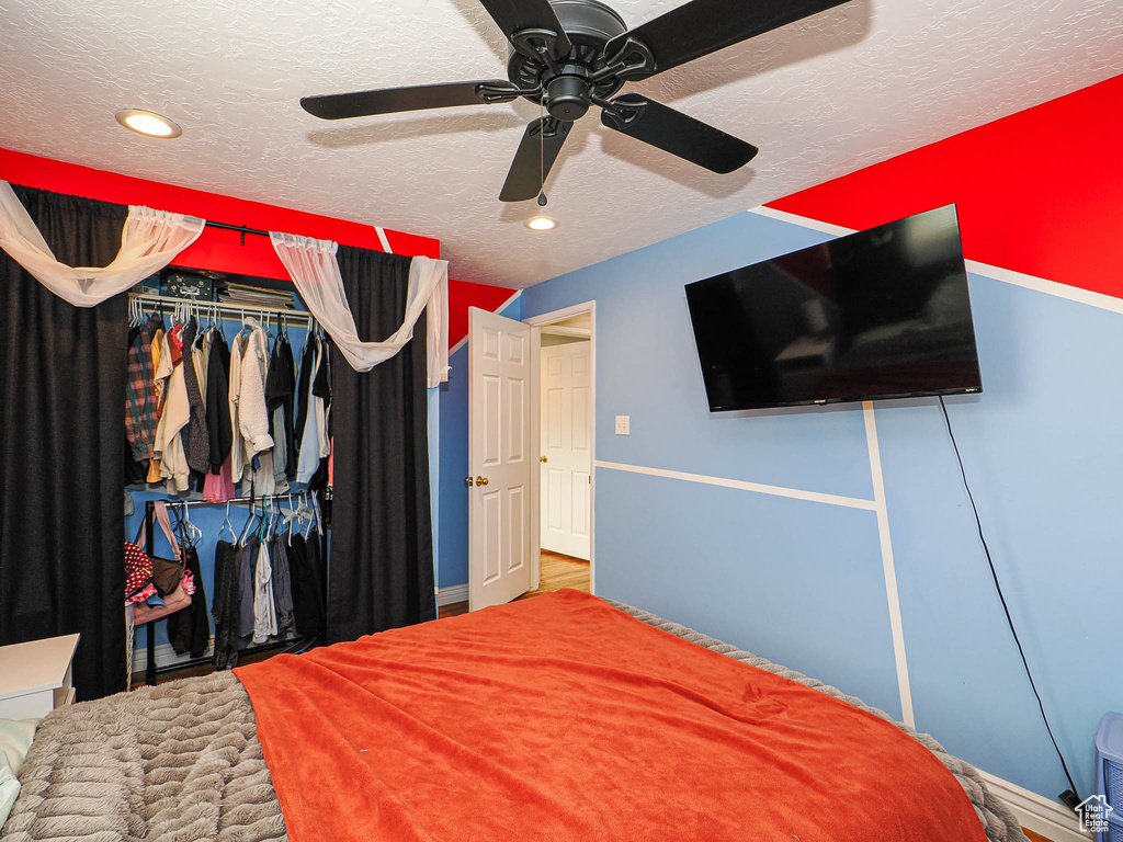 Bedroom with ceiling fan, recessed lighting, a closet, and a textured ceiling