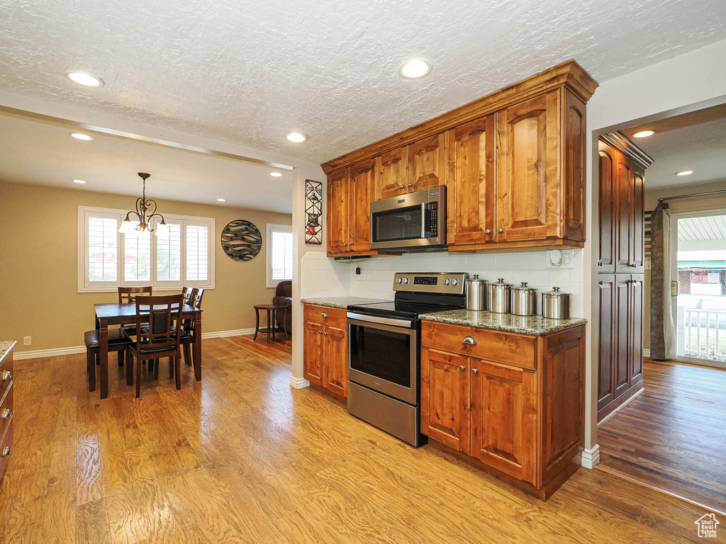 Kitchen featuring light wood-type flooring, a wealth of natural light, and stainless steel appliances