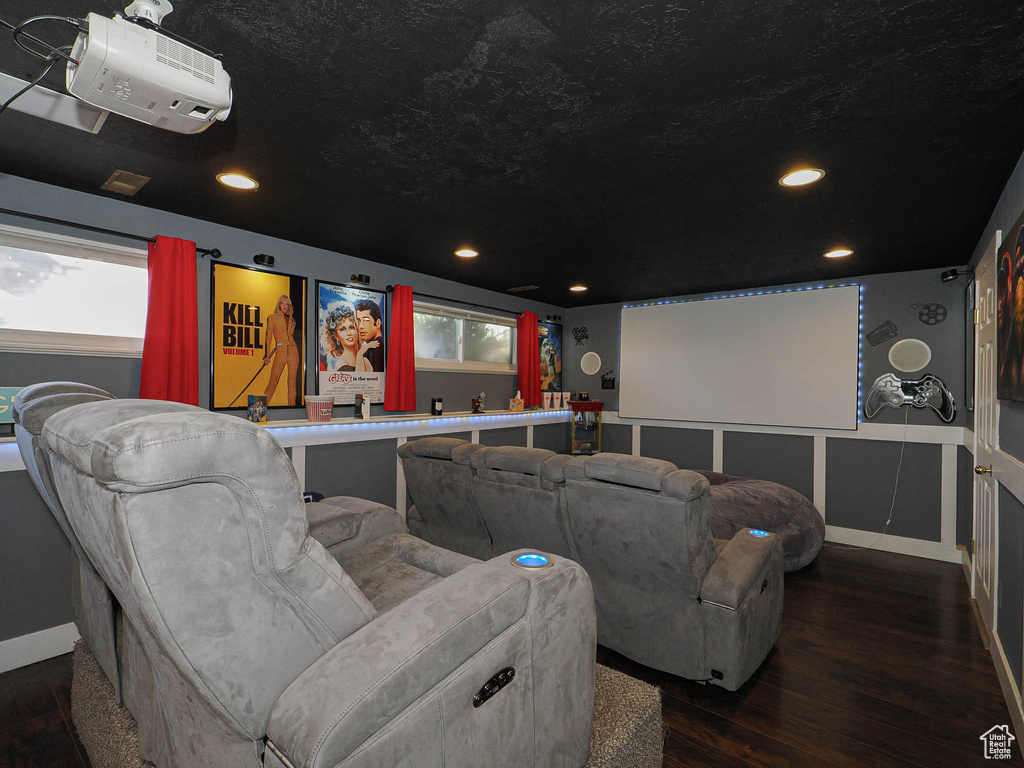 Cinema with recessed lighting, a wealth of natural light, a textured ceiling, and wood finished floors