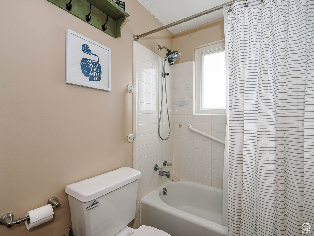 Full bathroom with toilet and shower / bathtub combination with curtain