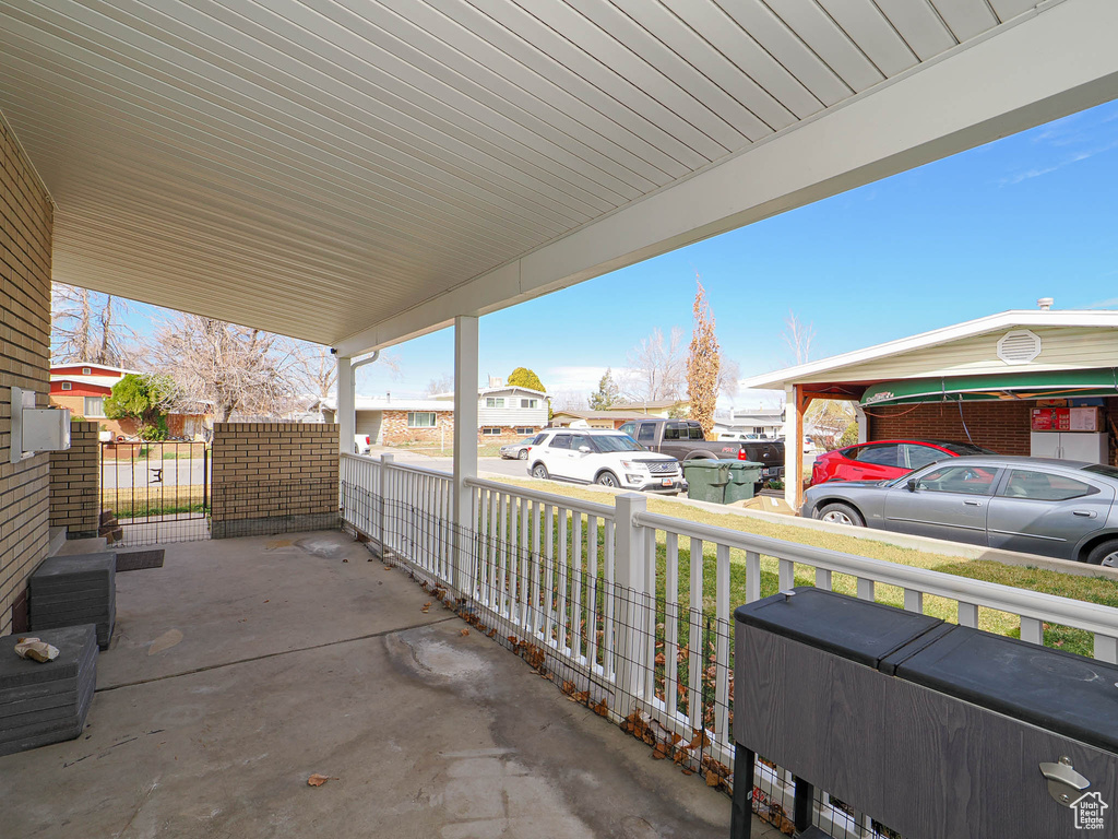 View of patio with a carport and covered porch