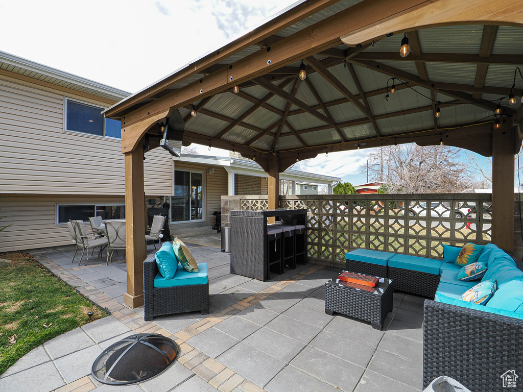 View of patio with a gazebo, outdoor dining space, and an outdoor hangout area