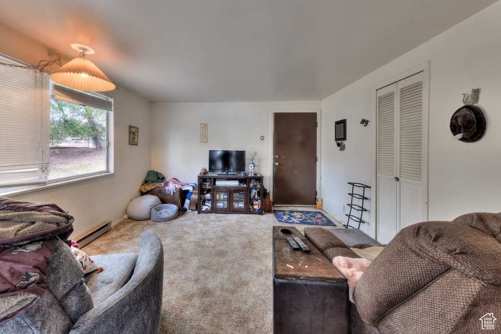 Carpeted living room with a baseboard heating unit