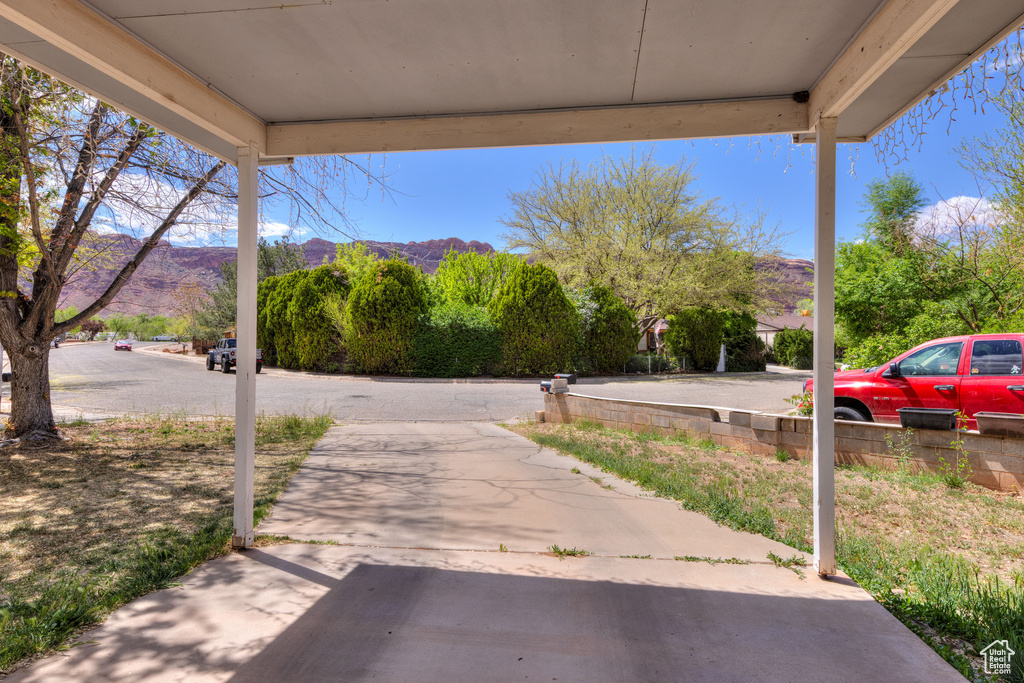 View of road with a mountain view and driveway