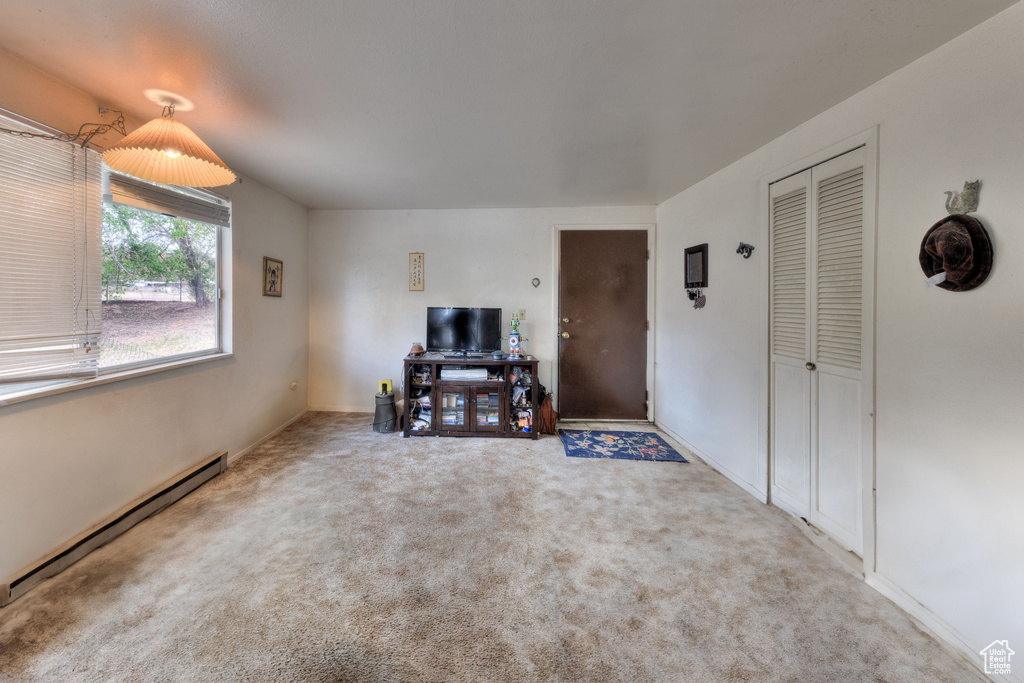 Living room featuring carpet and a baseboard radiator