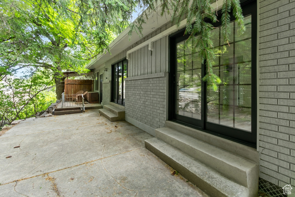 View of patio / terrace featuring entry steps and fence