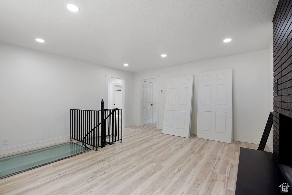 Spare room with recessed lighting, baseboards, and wood finished floors