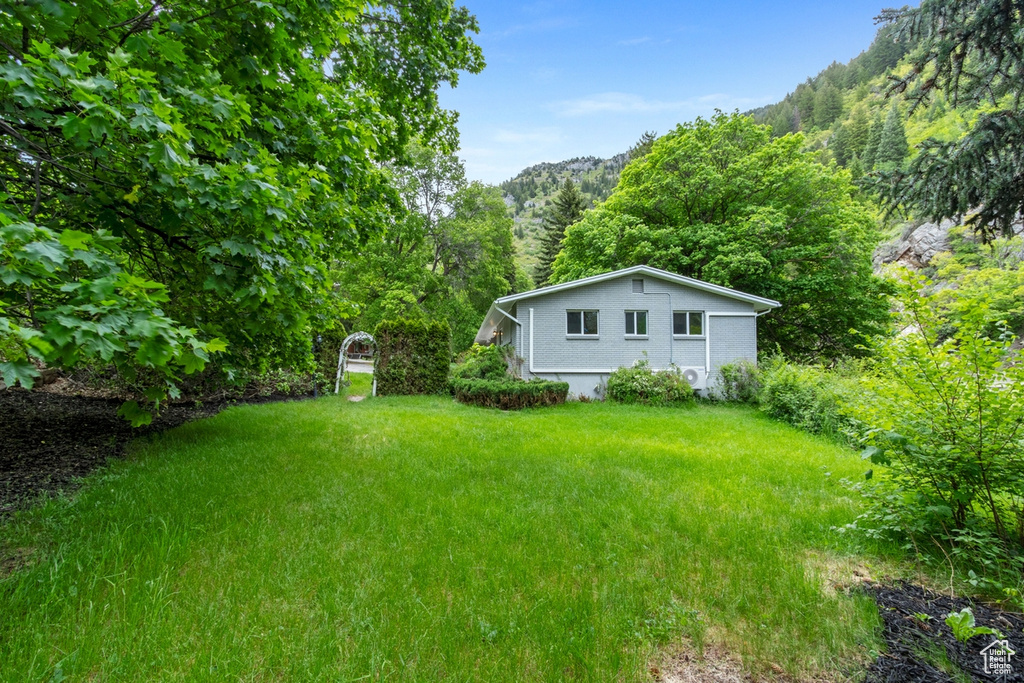 View of yard featuring a forest view