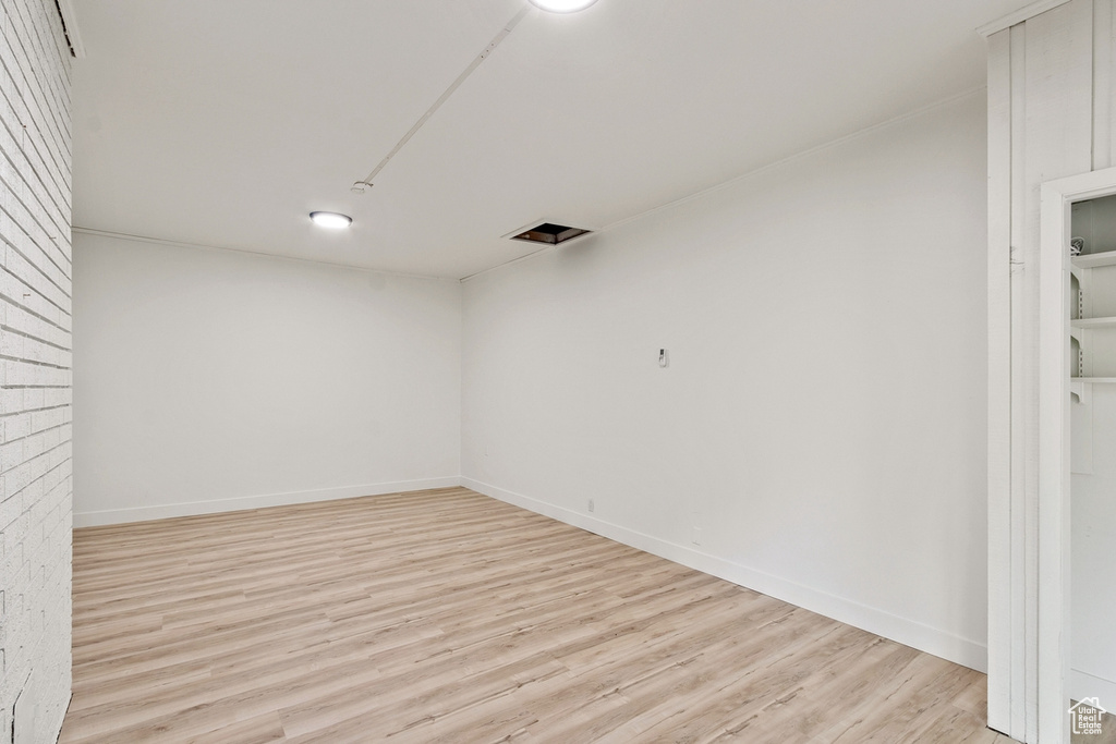 Unfurnished room featuring baseboards and light wood finished floors