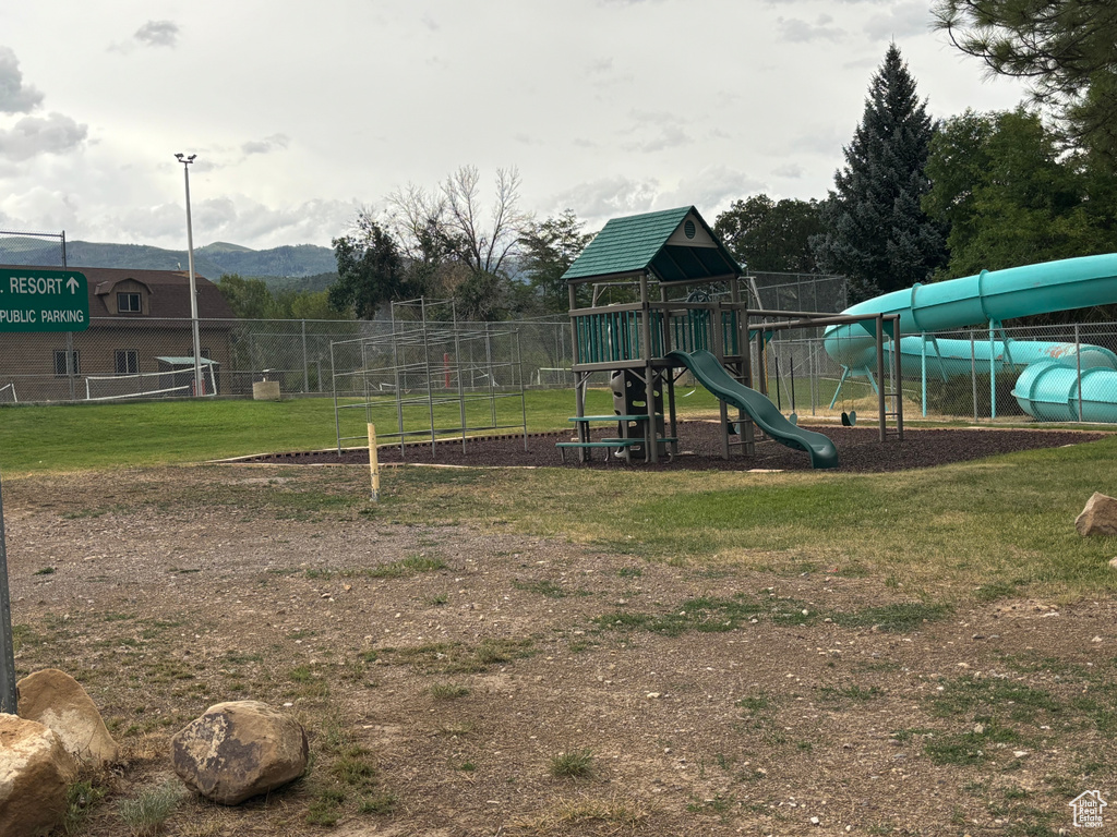 Community playground with a yard and fence