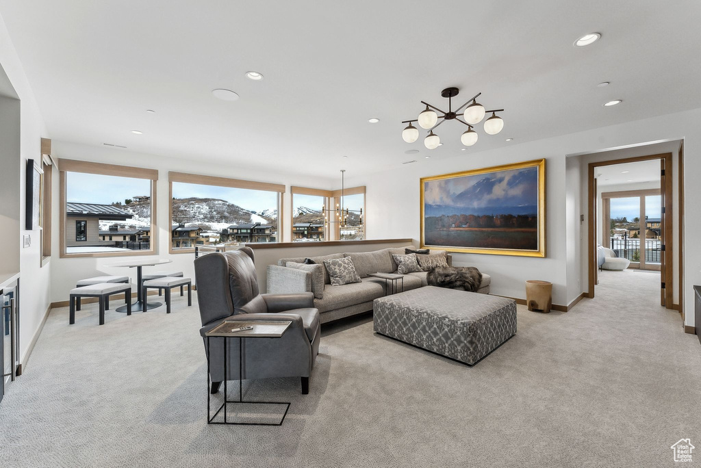 Living room with recessed lighting, baseboards, and light carpet