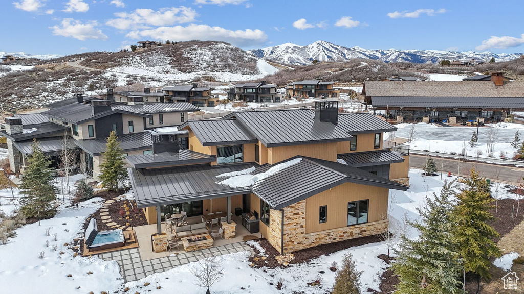 Snowy aerial view featuring a residential view and a mountain view
