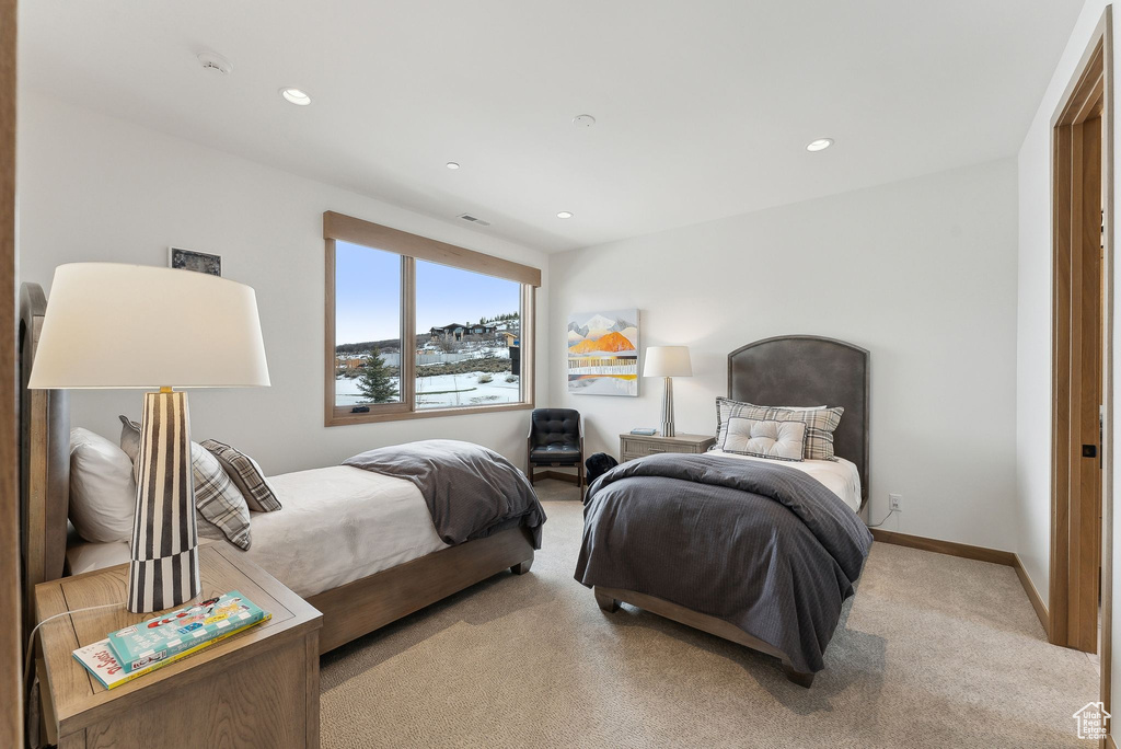 Bedroom with recessed lighting, light colored carpet, and baseboards
