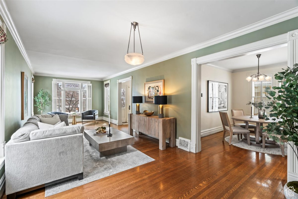 Living room featuring a wealth of natural light, visible vents, baseboards, and wood finished floors
