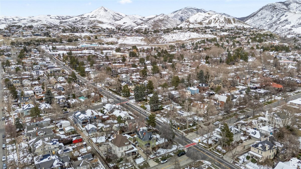 Snowy aerial view with a mountain view and a residential view
