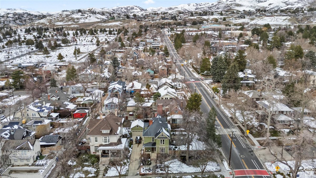 Snowy aerial view with a mountain view and a residential view