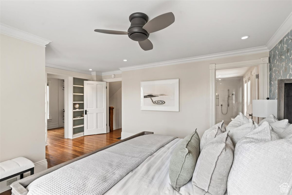 Bedroom with recessed lighting, connected bathroom, wood finished floors, and crown molding