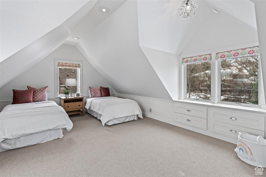 Bedroom with lofted ceiling, recessed lighting, and light colored carpet