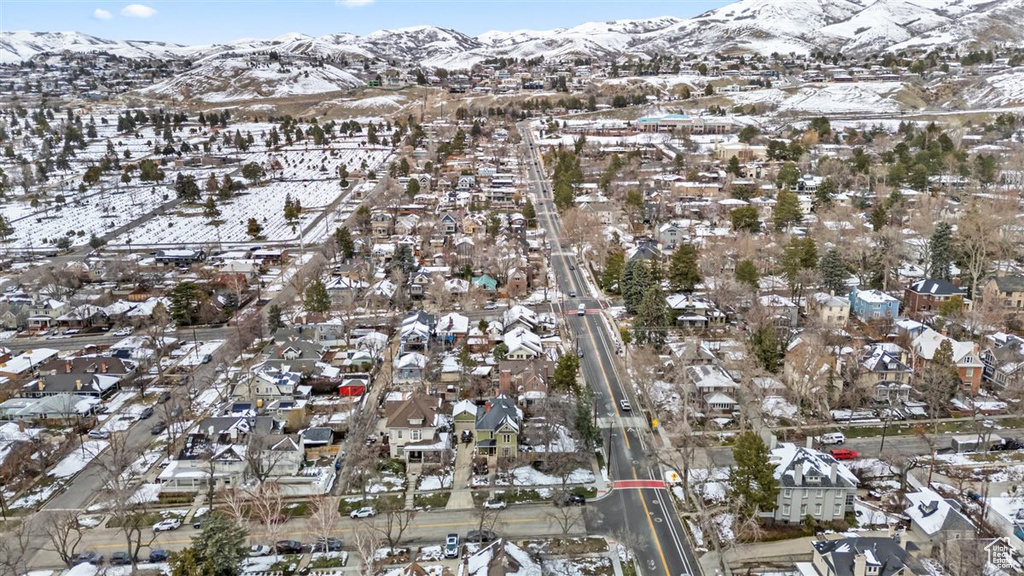 Snowy aerial view featuring a residential view and a mountain view