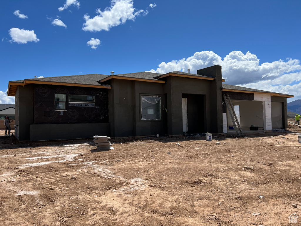 Exterior space featuring stucco siding and a garage