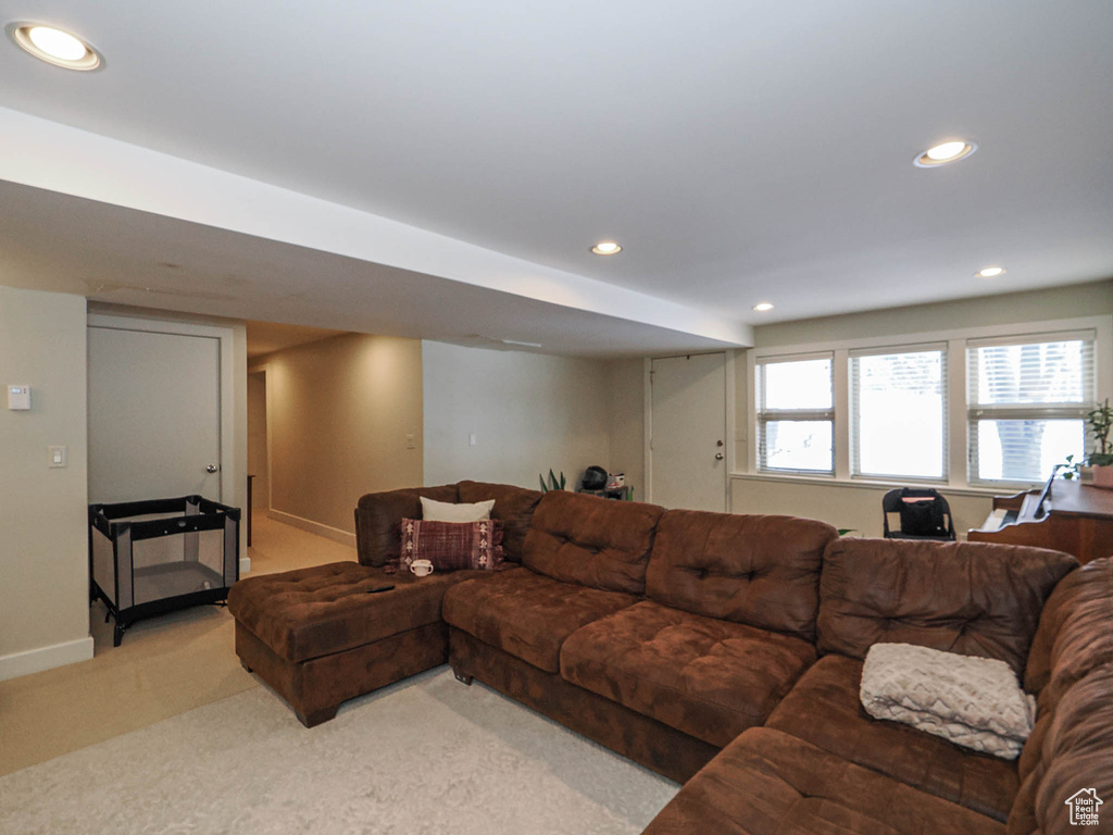 Living room featuring recessed lighting, baseboards, and light colored carpet