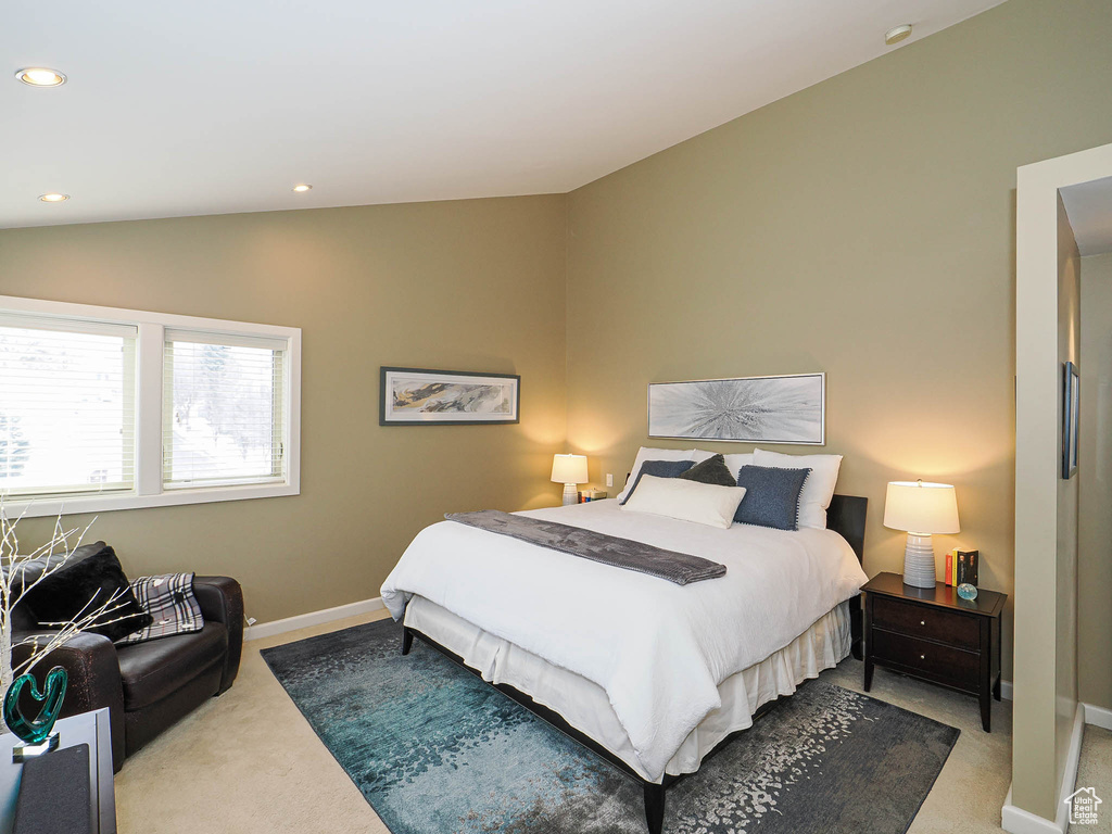 Carpeted bedroom with vaulted ceiling, recessed lighting, and baseboards