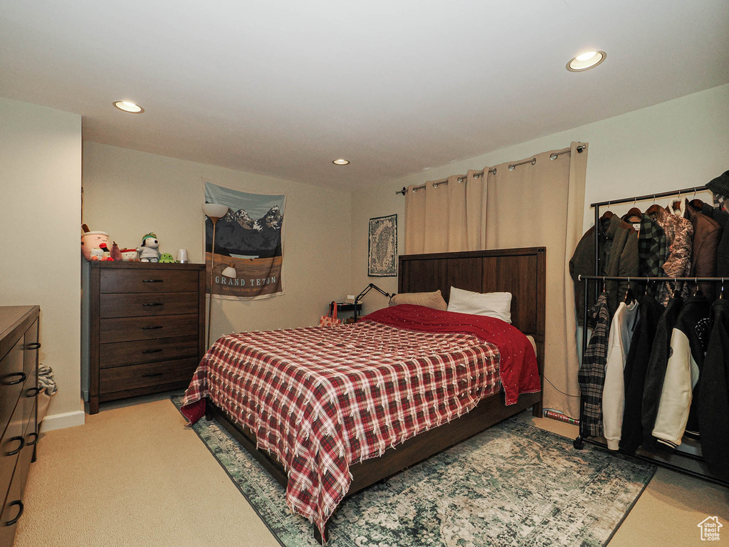 Carpeted bedroom with recessed lighting