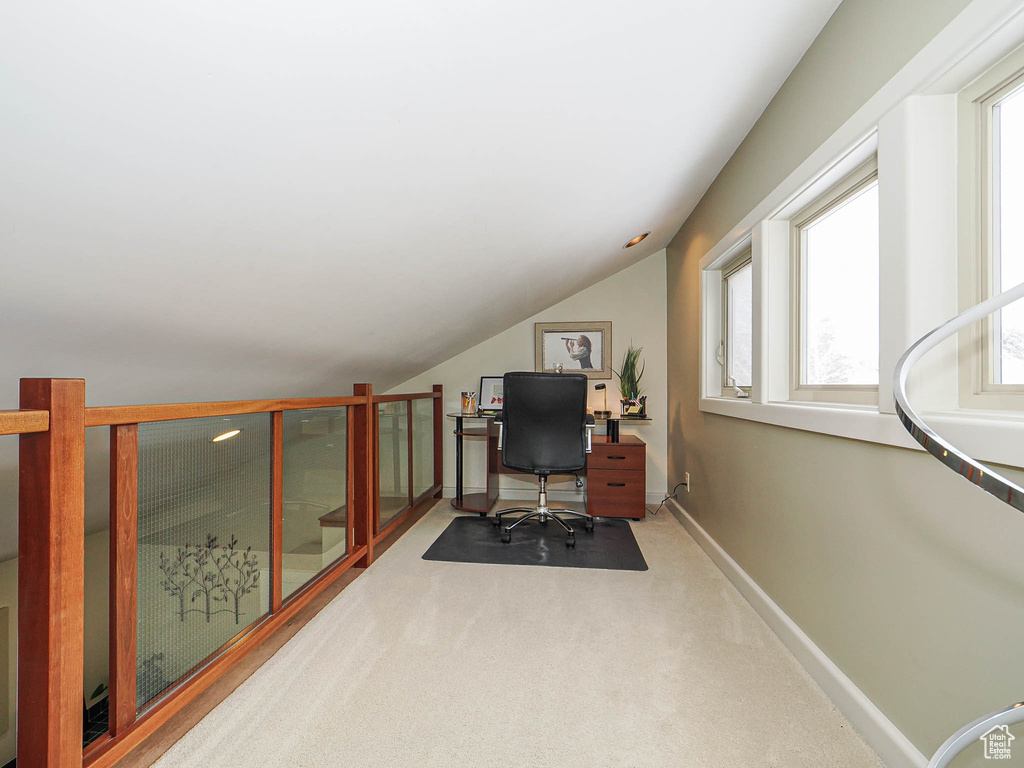 Office featuring vaulted ceiling, carpet flooring, and baseboards