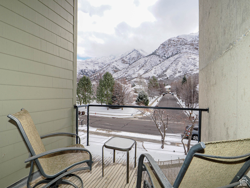 Snow covered back of property featuring a mountain view