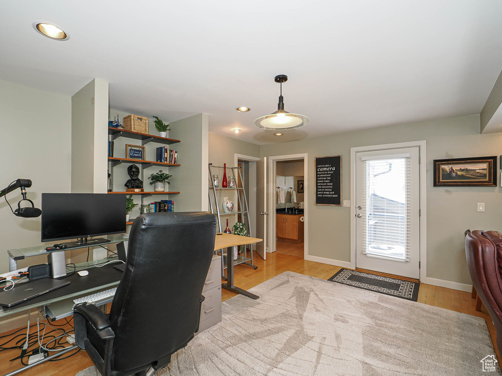 Home office featuring recessed lighting, baseboards, and light wood-type flooring