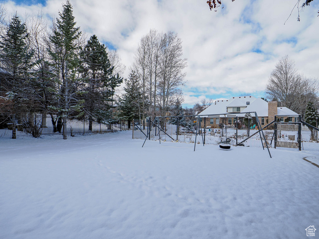 Yard covered in snow with fence