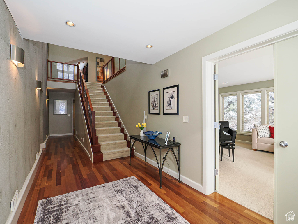 Foyer featuring stairway, wood finished floors, visible vents, baseboards, and recessed lighting